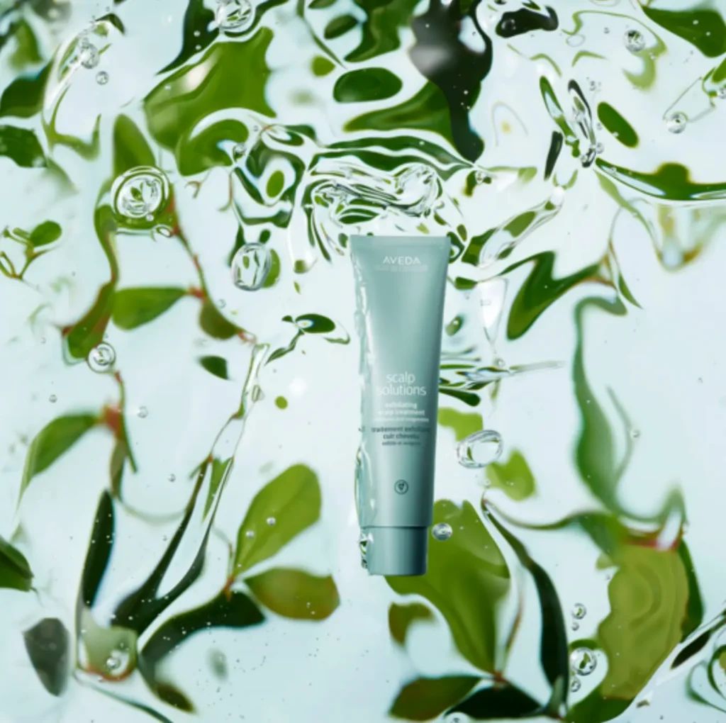 - The Color Bar, TX A tube of Aveda Scalp Solutions, part of the advanced skincare line, is suspended in water, with green leaves and air bubbles visible in the background. - The Color Bar, TX